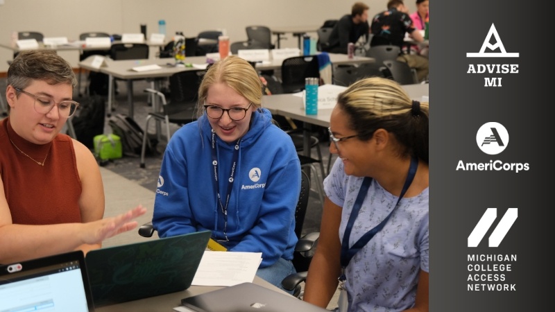 3 people sitting at a table working on a laptop