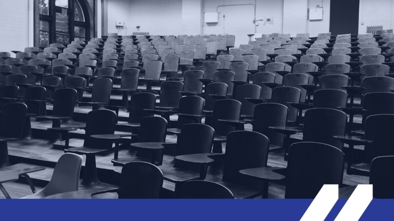 Image of a college classroom full of empty chairs.