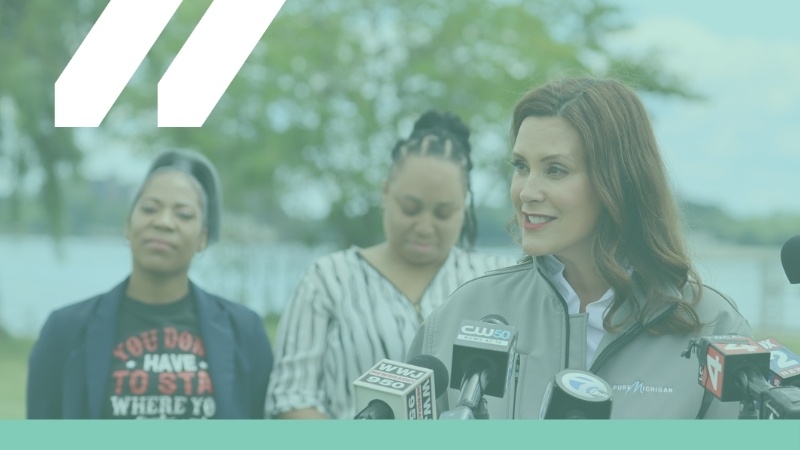 Governor Gretchen Whitmer speaking at podium outside, with teal overlay and MCAN logo in white in top left corner