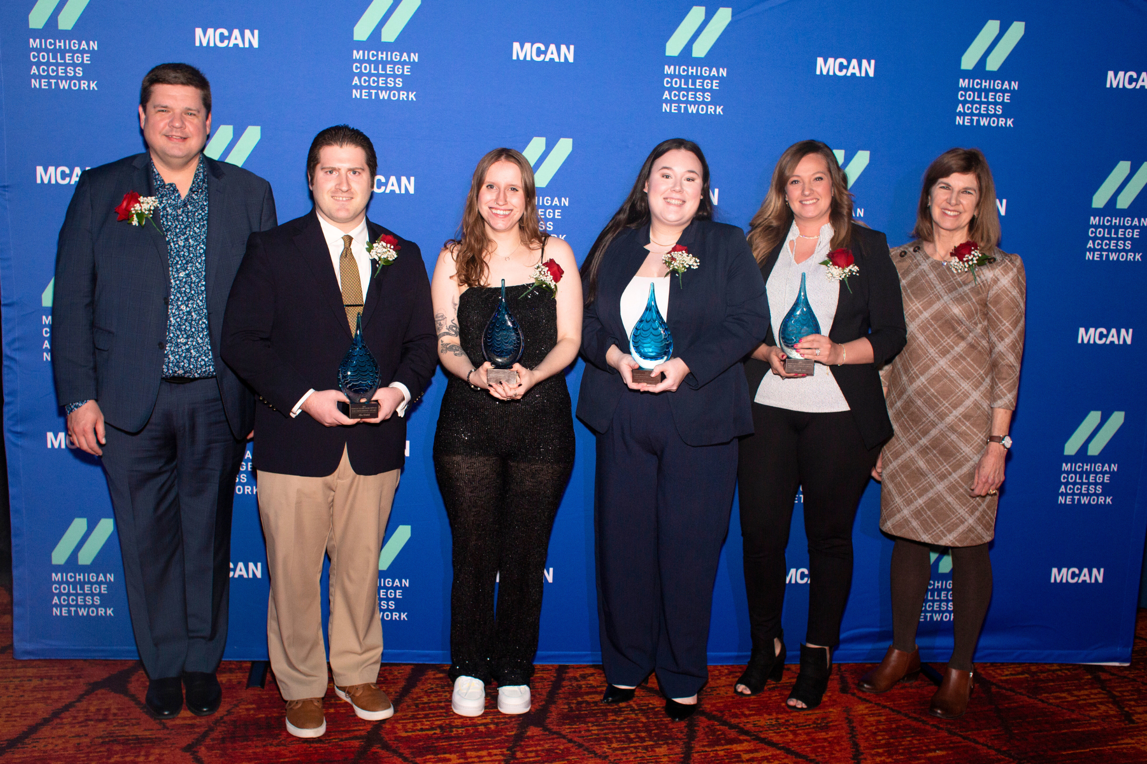 Group of people posing with awards