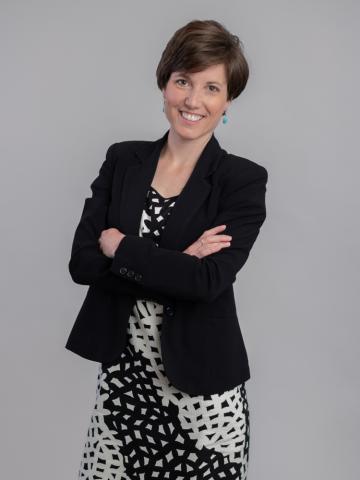 Jenny McArdle wearing a print dress and black jacket