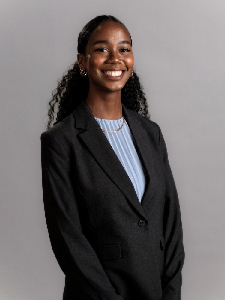 Genesia Thompson wearing a blue shirt and dark gray coat